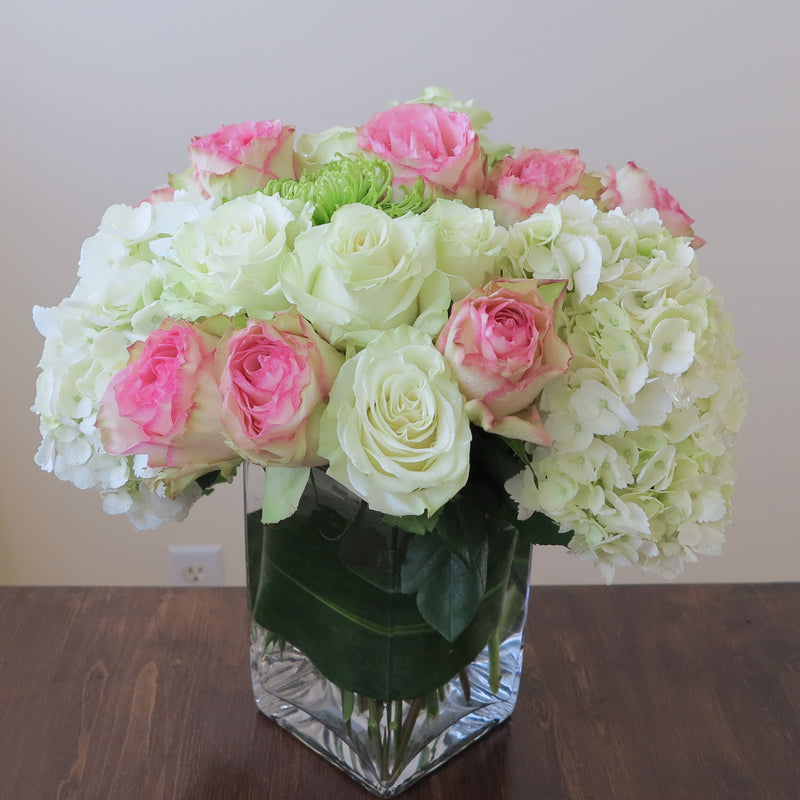 Flowers used: pink blush and white roses, green chrysanthemums, white hydrangeas