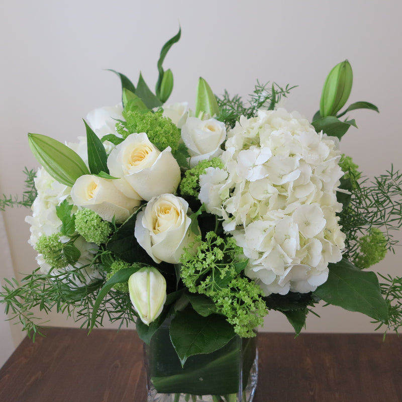 Flowers used: white roses, white hydrangeas, white lilies, green viburnum