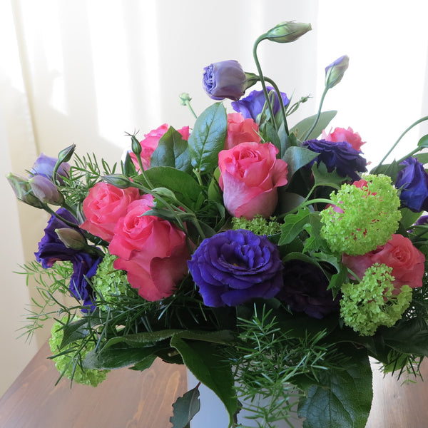 Flowers used: purple lisianthus, pink roses and, green viburnum