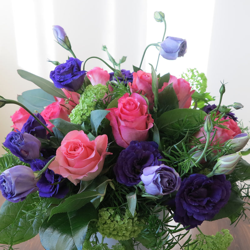 Flowers used: purple lisianthus, pink roses and, green viburnum