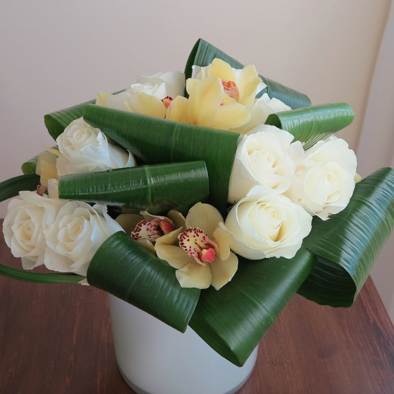 Flowers used: cream white roses, yellow cymbidium orchids