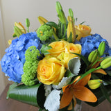 Flowers used: yellow roses, blue hydrangeas, yellow lilies and green viburnums