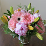 Flowers used: orange lilies, salmon pink roses and gerberas, pink peonies