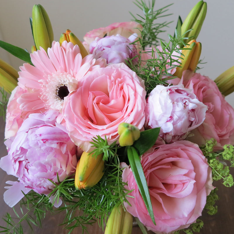 Flowers used: orange lilies, salmon pink roses and gerberas, pink peonies
