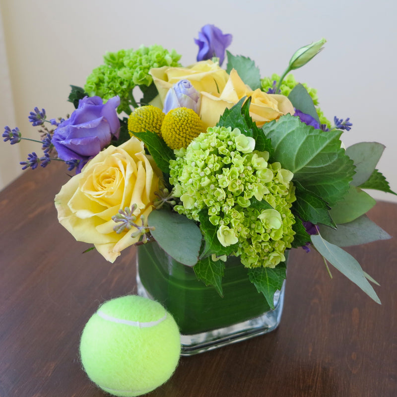 Flowers used: yellow roses, purple lisianthus, green hydrangeas