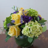 Flowers used: yellow roses, purple lisianthus, green hydrangeas, seeded eucalyptus