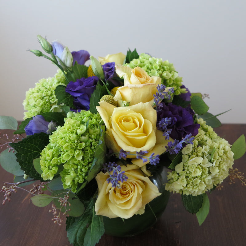 Flowers used: yellow roses, purple lisianthus, green hydrangeas, seeded eucalyptus