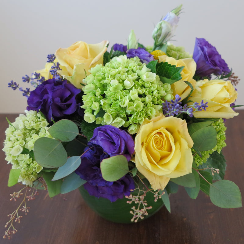 Flowers used: yellow roses, purple lisianthus, green hydrangeas, seeded eucalyptus