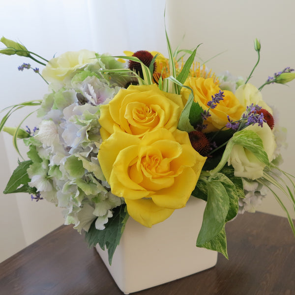 Flowers used: yellow roses, cream lisianthus, blue lavender, orange protea and rusty hydrangeas