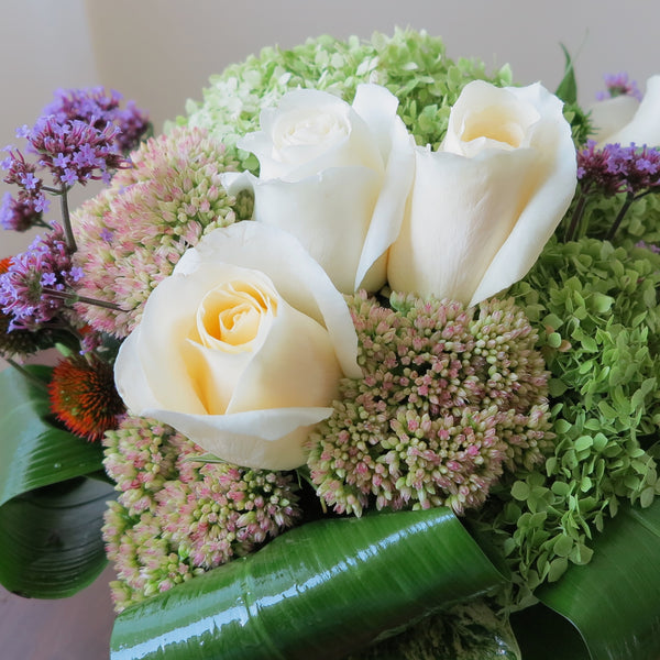 Flowers used: green hydrangeas, cream roses, blue verbena and pink sedums