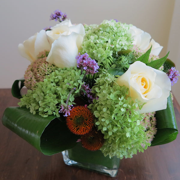 Flowers used: green hydrangeas, cream roses, blue verbena and pink sedums