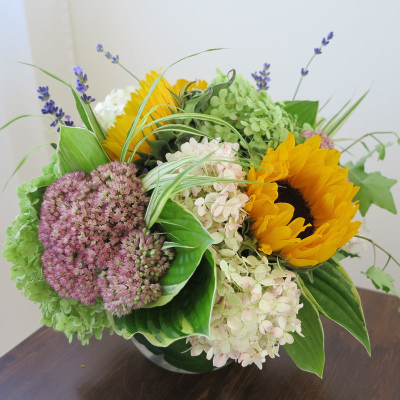 Flowers used: soft white and green hydrangeas, warm yellow sunflowers, rusty pink sedums