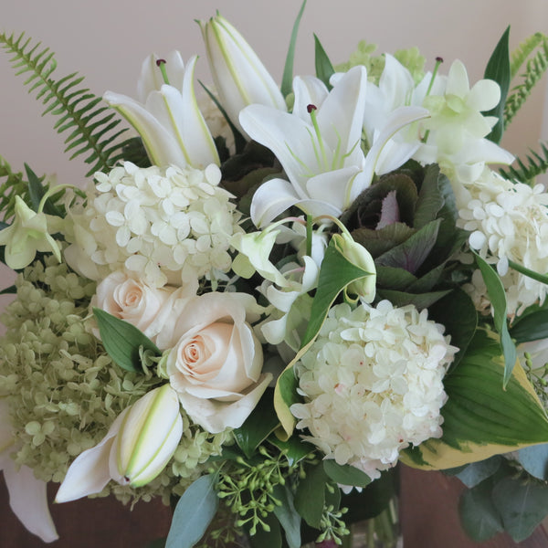 Flowers used: cream roses, white and green hydrangeas, white orchids, white lilies, green kales