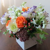 Flowers used: purple/white lisianthus, white orchids, orange roses, green chrysanthemums, pink hypericums and cream dahlias