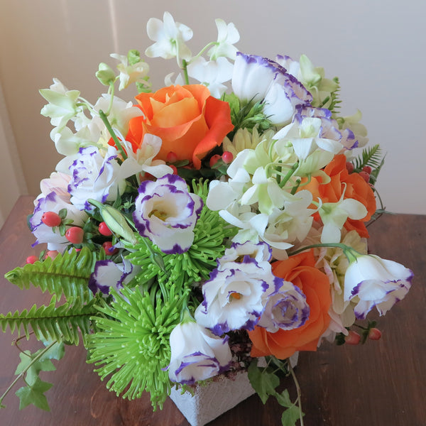 Flowers used: purple/white lisianthus, white orchids, orange roses, green chrysanthemums, pink hypericums and cream dahlias