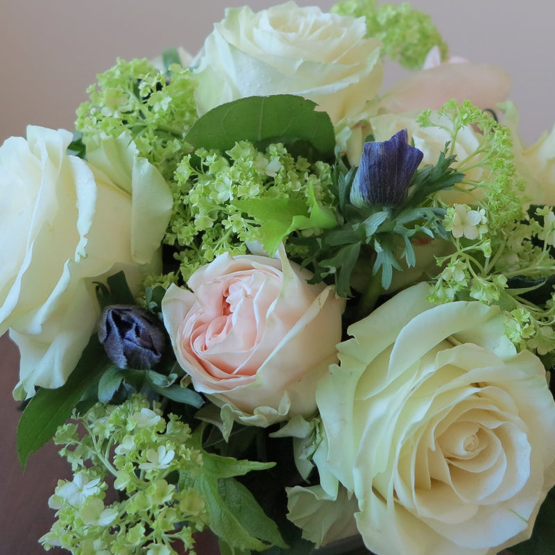 Flowers used: white and pink roses, green viburnums, blue anemones