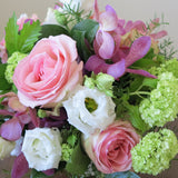 Flowers used: pink roses, mauve orchids, white lisianthus and green viburnum