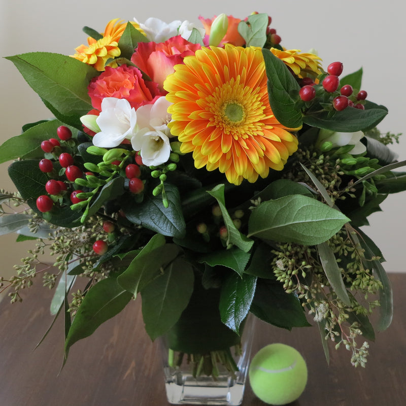 Flowers used: orange roses and gerberas, white freesias, red hypericum berries, green seeded eucalyptus